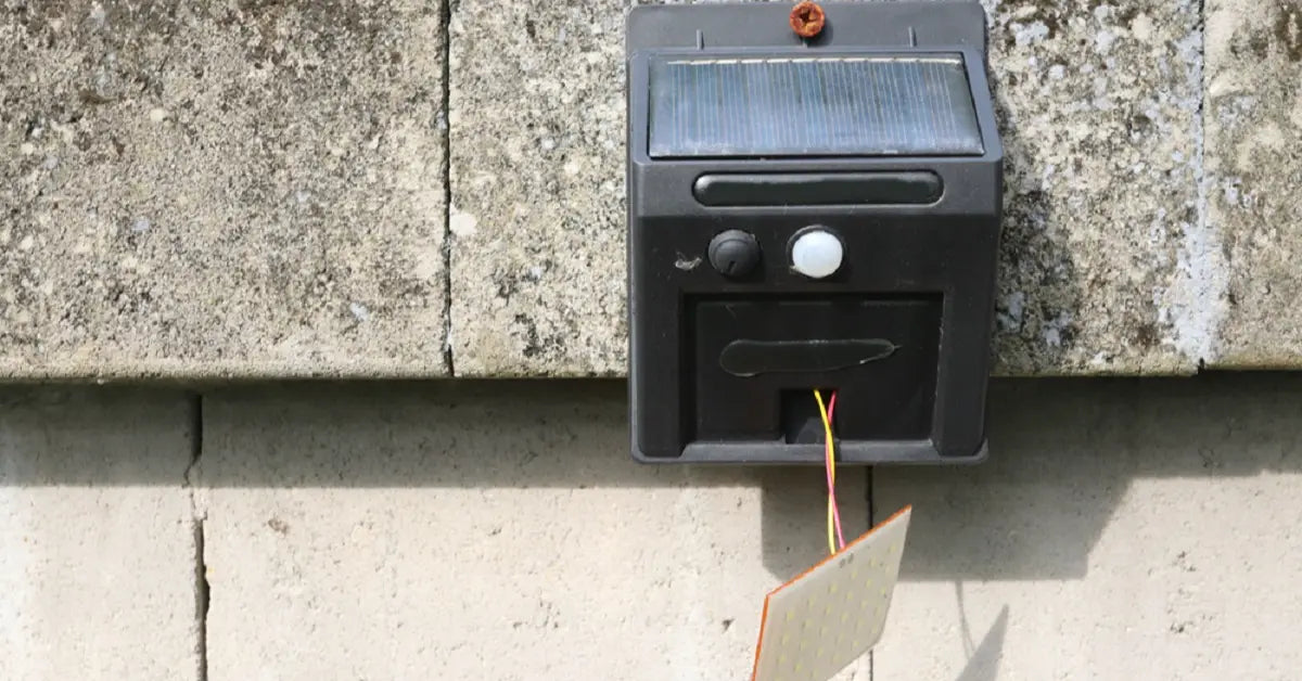 A solar flood light with its accompanying solar panel, featuring a clear battery level and charging indicator display to know if the solar light is charging.