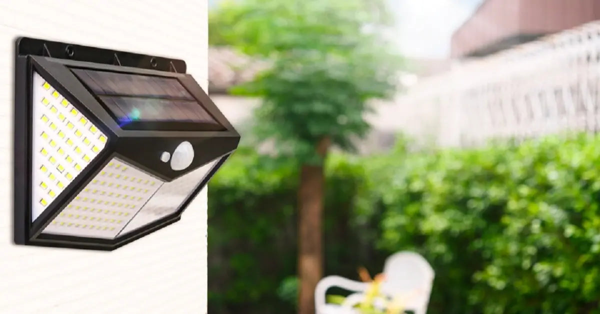 Black motion sensor solar wall light with multiple LED panels mounted on an exterior house wall, ideal for outdoor security and patio lighting.