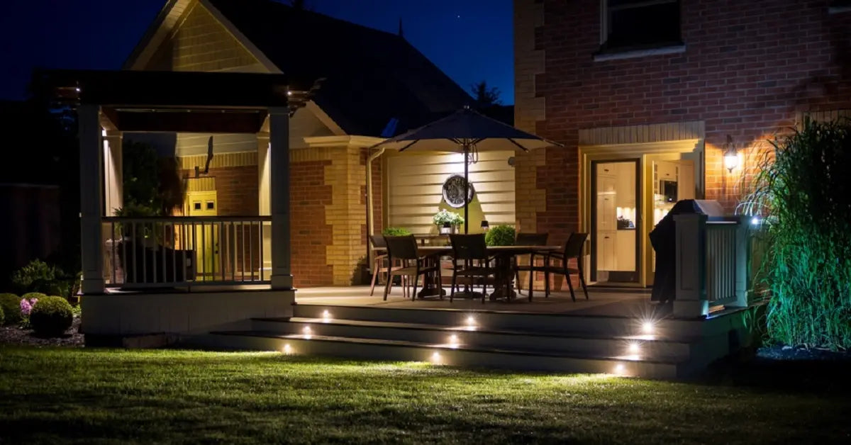 4000K neutral white outdoor lights on patio steps and deck, providing clear, bright illumination for a backyard dining area at night.