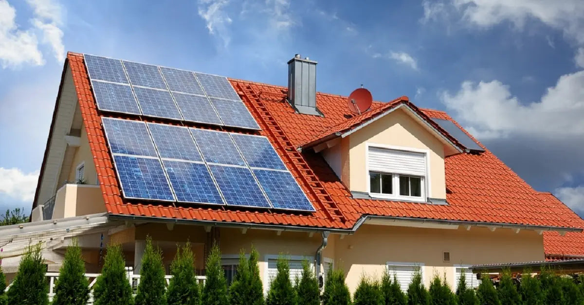 A modern house with solar panels on the roof under a sky with both clouds and sun, showing that panels can generate electricity using diffused daylight, not just direct sunlight.