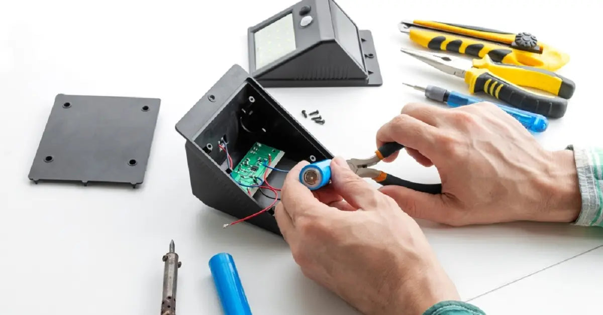 Hands-swapping-worn-out-battery-in-solar-light-as-a-repair-solution