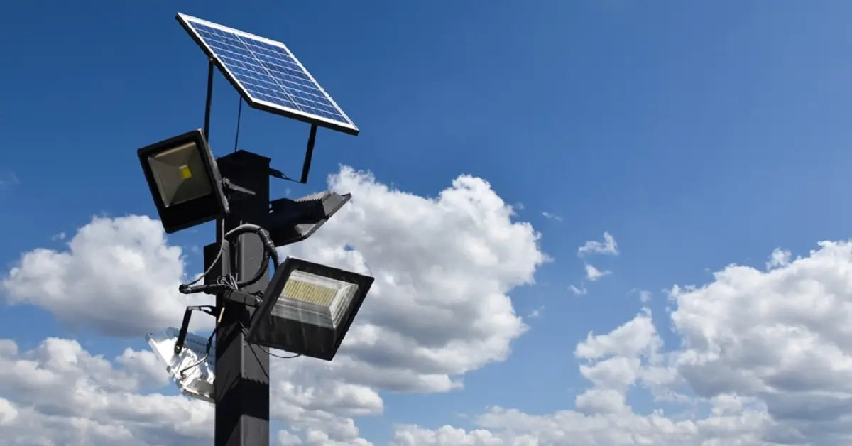 A powerful commercial solar street light with multiple high-lumen LED floodlights and a large solar panel, charging under a clear blue sky, showcasing the maximum brightness available for outdoor security.