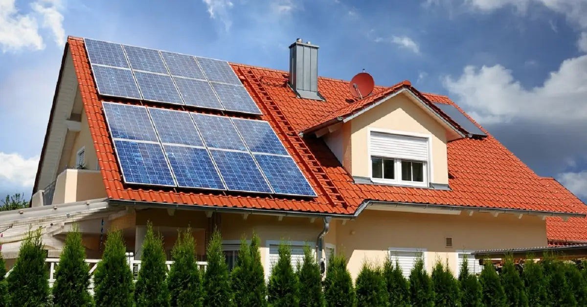 A large residential solar panel array on a red-tiled roof, illustrating a system designed with the 20% rule, which involves oversizing the panels relative to the inverter to maximize year-round energy production.