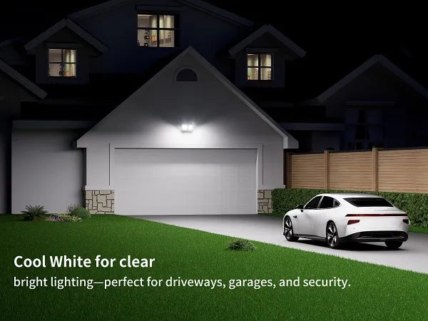 Ultra bright 6500K cool white solar security light providing clear illumination for a home garage and driveway.