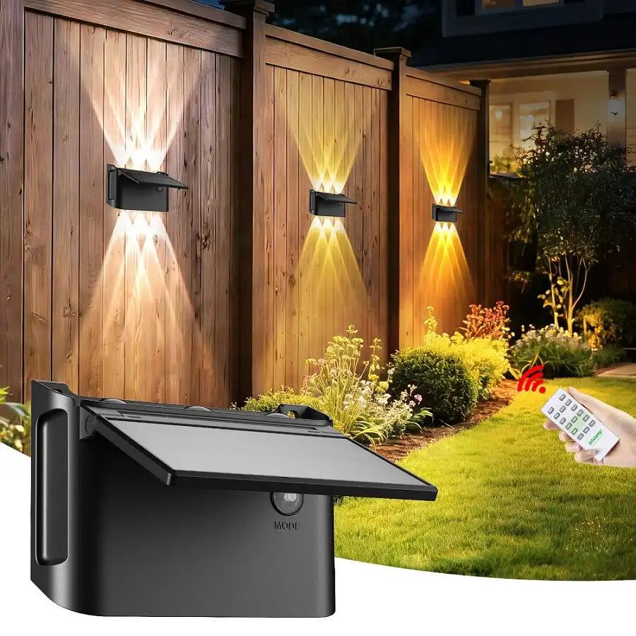 intelamp modern solar up and down wall light with remote control, illuminating a wooden garden fence.